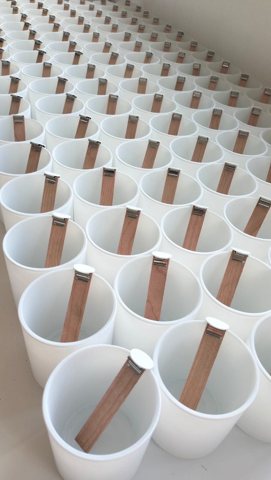 Rows of white Sere candle vessels ready for a bulk gift order